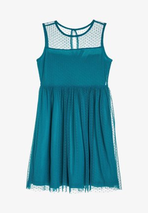 Robe turquoise sans manches longueur genou avec superposition en tulle à pois sur le corsage et la jupe, encolure ronde et fermeture au dos avec œillet.