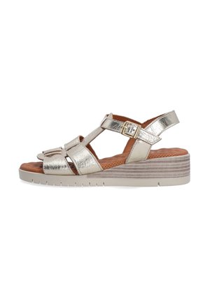 Metallic silver wedge sandals with an open toe design, featuring cross straps, adjustable buckle, and a textured brown insole.