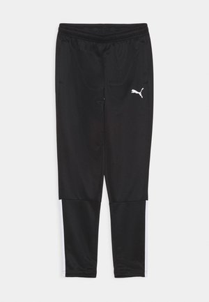 Schwarze Sporthosen aus glattem, leichtem Stoff. Mit einem weißen Logo und vertikalen weißen Streifen an den Bündchen. Elastischer Bund.