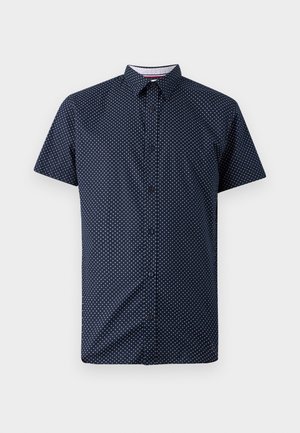 Camicia a maniche corte in tessuto blu navy con un motivo a pois bianchi, dotata di chiusura a bottoni e colletto classico.