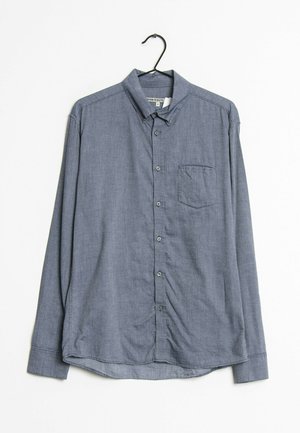 Camicia a maniche lunghe in blu navy con un piccolo motivo a scacchi, chiusura con bottoni, taschino sul petto e orlo curvo.
