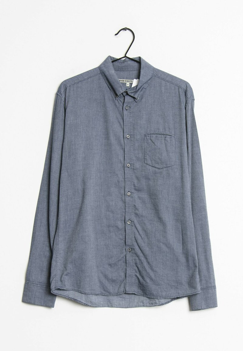 Košile s dlouhým rukávem v námořnické modré barvě s malým kostkovaným vzorem, zapínání na knoflíky v přední části, jediná náprsní kapsa a zakřivený lem.