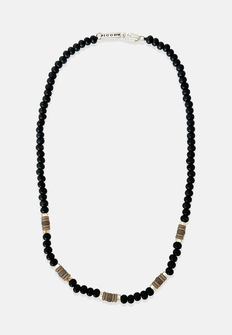 Fekete gyöngy nyaklánc fémes és texturált díszítményekkel. Sima fekete gyöngyök, melyeket barna és arany árnyalatú kiegészítők váltogatnak. Biztonságos kapocs zár.