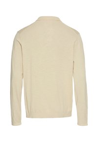 Lys beige langærmet sweater med polo krave. Har en glat tekstur og en ribbet kanten. Minimalistisk design uden yderligere mønstre.