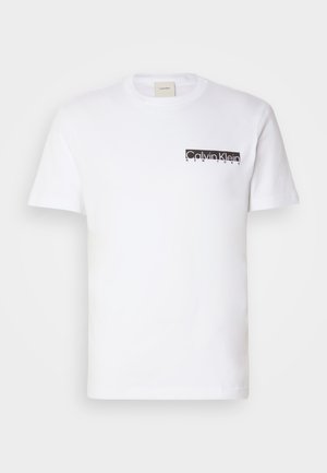 White cotton T-shirt with short sleeves and crew neck, featuring a black printed "Calvin Klein New York" logo on the left chest pocket area.