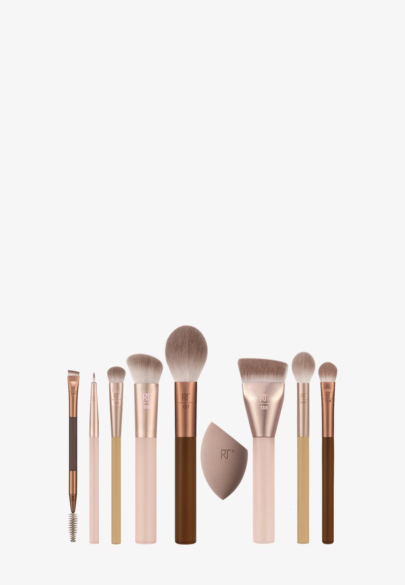 Eight makeup brushes and one makeup sponge, arranged in a row on a white background, with various handle colors and brush shapes.