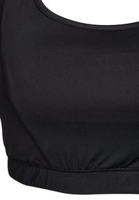 Must be spordiline rinnahoidja, mis on valmistatud siledast ja venivast kangast. Omab ümarat kaelust, pehmeid õmblusi ja elastset hemmi, tagamaks kindlat istuvust.