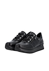 Black leather sneakers featuring lace-up closure and side zipper. Smooth texture, rounded toe, and layered sole with contrasting stripes.