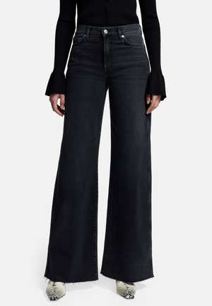 Højtaljede, brede ben sorte denimjeans med frynset kant, knaplukning og sidelommer. Glat tekstur og struktureret pasform.