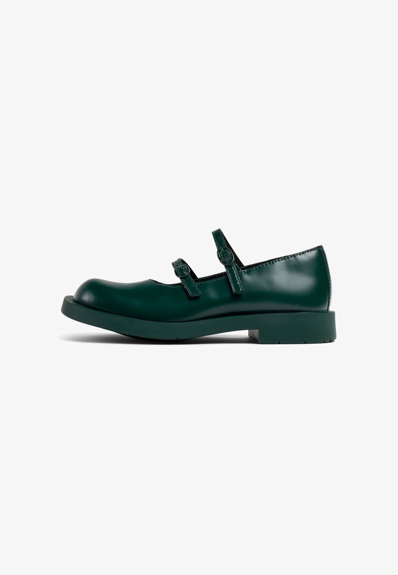Green patent leather Mary Jane shoes with two adjustable straps and a rounded toe, featuring a flat rubber sole.