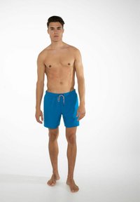 Blå badshorts i lätt tyg med elastisk midjeband och dragsko, med en enfärgad och avslappnad passform.