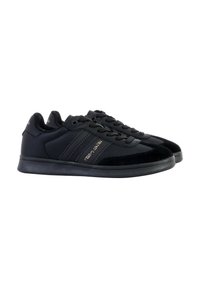 Black athletic shoes featuring smooth synthetic material, lace-up design, suede accents, rubber sole, and subtle branding on the side.