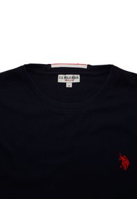 Fekete U.S. Polo Assn. póló, kerek nyakkal, közepes méretű címkével, és kis piros hímzett polo játékos logóval a mellkasán.