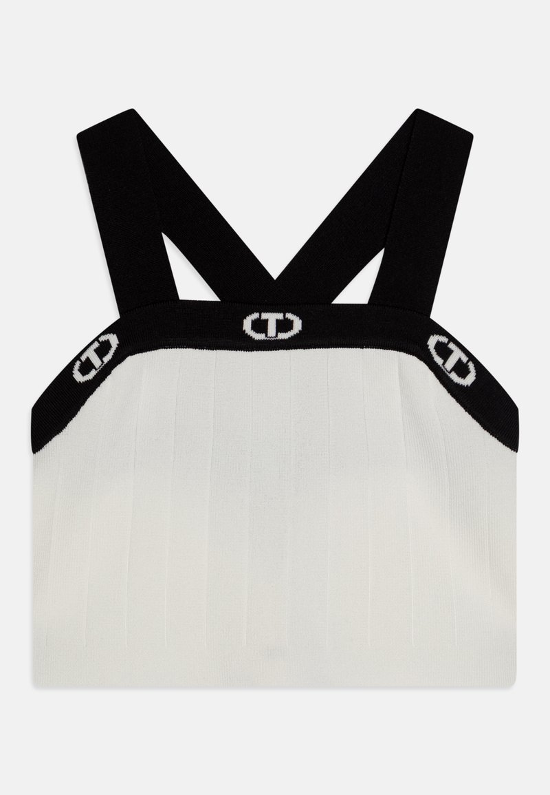 Svarte og hvite strikkede crop-topper med kryssede stropper, ribbet tekstur, logo-bånd nederst og en tettsittende silhuett.