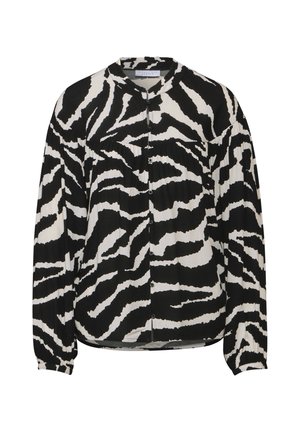 Blouse à manches longues noir et blanc avec un motif zèbre, un col rond et des boutons sur le devant. Tissu doux et léger.