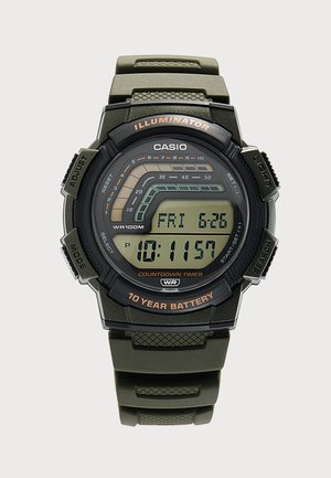 Montre de sport numérique Casio avec boîtier noir et vert, minuterie de compte à rebours, éclairage, date, heure et indication de batterie de 10 ans.
