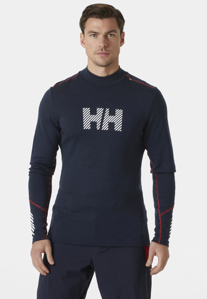 Marineblauwe langekous shirt met hoge kraag, met een witte "HH" logo, rode schouderaccenten en gestreepte details op de mouwen. Rekbare stof.