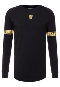 Schwarzes Langarmoberteil aus Baumwolle mit rundem Halsausschnitt. Verfügt über ein goldenes Logo auf der Brust und ein goldenes Band mit Text an den Ärmeln.