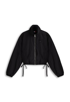 Veste noire zippée avec col montant, poignets élastiques et cordons ajustables à la taille, présentée sur un fond blanc.