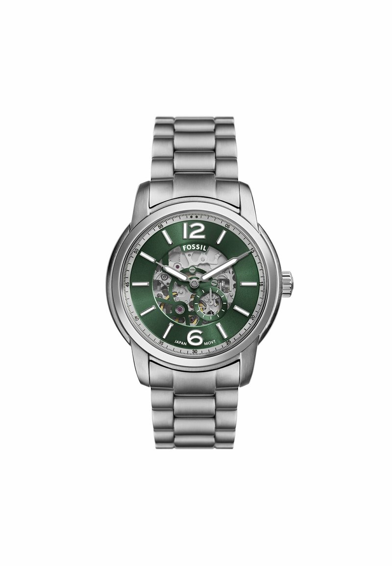 Silberner Edelstahl-Uhren mit grünem Ziffernblatt, transparentem Gehäuse, weißen Stundenmarkierungen und einem Mesh-Armband. Zeigt die sichtbaren inneren Mechanismen.