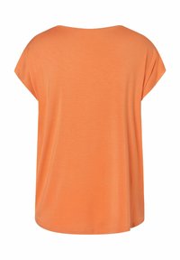 Korte mouwen, ronde hals top in effen oranje, gemaakt van een zachte, lichte stof met een losse pasvorm en een gebogen onderrand.