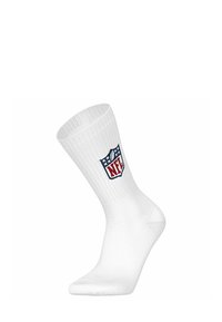 Calcetín deportivo blanco con textura acanalada, que presenta un logo de la NFL en azul y rojo en el lado. Fabricado con material cómodo y elástico.