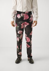 Black floral trousers featuring vibrant pink rose patterns, made from lightweight fabric, with a relaxed fit and standard waistband.