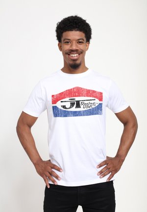 White cotton t-shirt featuring a bold graphic in red and blue with "J.T. Racing USA" in black, round neckline, short sleeves.