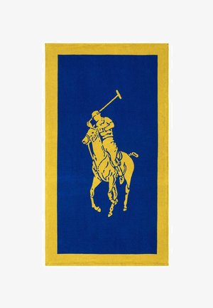 Tapis rectangulaire bleu avec une bordure jaune, présentant une silhouette jaune d'un joueur de polo à cheval brandissant un maillet.