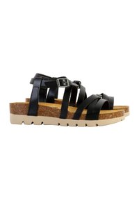 Sandalias de cuero negro con múltiples correas cruzadas y hebilla ajustable. Plantilla de corcho sobre una suela de goma beige clara con textura antideslizante.
