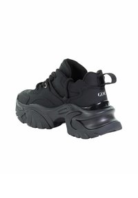 Czarne, masywne sneakersy z teksturowaną gumową podeszwą, okrągłym noskiem, sznurowanym przodem, wyściełanym kołnierzem oraz pętlą na tyle ułatwiającą zakładanie.