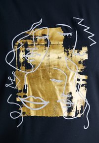 Black fabric features a gold foil design with abstract line drawings of faces, accented by white outlines and irregular shapes.