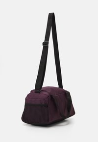 Puma FUNDAMENTALS BAG XS UNISEX - Športna torba - midnight plum