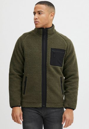 Olive green fleece jacket with a black zippered chest pocket and side pockets, full front zip, and elastic cuffs. Textured surface.