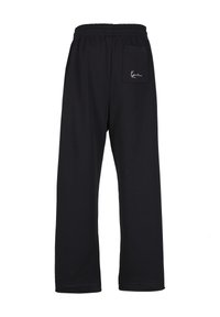 Mustad vaba lõikega dressipüksid, kummiga vöökohaga ja tagumisel küljel ühe taskuga, millel on väike tikitud logo. Pehme puuvillane materjal.