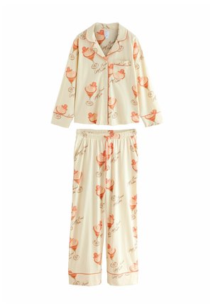 Cotton pajama set featuring a light cream base with orange dessert illustrations. The top has long sleeves with a button closure; pants have an elastic waistband.