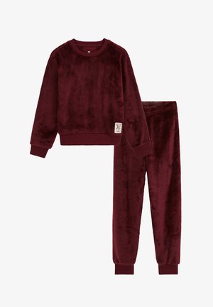Sweat-shirt bordeaux en polaire douce à manches longues et pantalon assorti avec taille élastiquée, poignets côtelés et petite étiquette sur le devant du sweat-shirt.