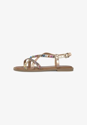 Gold-tone flat sandals with multicolored beaded accents, braided straps, and a buckle closure. Smooth sole with decorative stitching along edges.