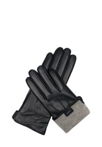 Een paar zwarte leren handschoenen met beige gebreide manchetten, waarop een gelabeld label op één manchette te zien is, plat uitgespreid op een witte achtergrond.