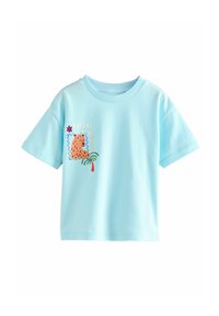 T-shirt en coton bleu clair à manches courtes, avec un graphique de léopard orange, des détails de palmier et le texte "del sol al mar".