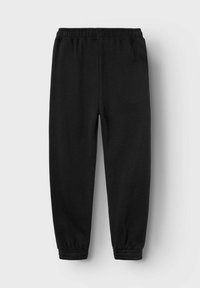 Schwarze Jogginghosen mit elastischem Bund und Bündchen, aus weichem Material, mit einem schlichten Design ohne Taschen oder Muster.