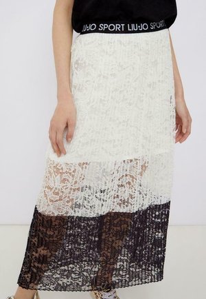Jupe longue en dentelle avec un dégradé allant du blanc au brun foncé. Taille élastique avec le logo "LIU JO SPORT". Texture transparente, coupe fluide.
