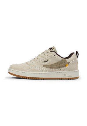 Beige suede sneaker with a dark brown accent, white midsole, and gum rubber outsole. Features Fila logo on the side and a padded collar.