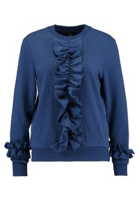 Námořnická modrá mikina s dlouhými rukávy a volánkovým materiálem, který běží svisle po přední straně a kolem manžet.