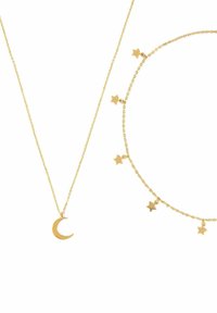 Złoty naszyjnik z wisiorkiem w kształcie półksiężyca oraz dopasowana bransoletka ozdobiona małymi gwiazdkami, obie z delikatnymi wzorami łańcuszka.