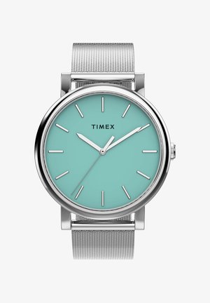 Silver mesh band watch with turquoise face, silver hour markers, and hands showing 10:09:10, brand name Timex on dial.