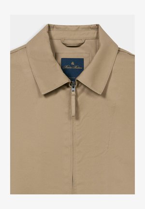 Beige Jacke mit Kragen, vorn mit Reißverschluss und Brooks Brothers Etikett im Krageninnenteil.