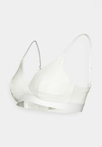 White bralette with ribbed texture, adjustable straps, and a smooth underband. Soft fabric construction for comfort and flexibility.