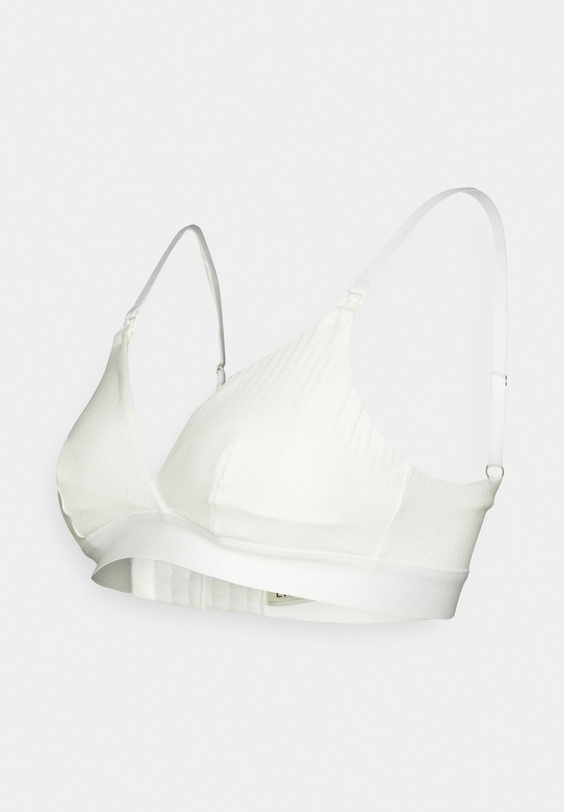 White ribbed bralette with adjustable straps and a wide band under the bust. Smooth texture and no underwire for comfort.