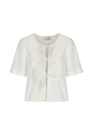 Blouse blanche à manches courtes en tissu ajouré, col rond, avec trois liens de fermeture à l'avant, présentant une taille légèrement froncée.